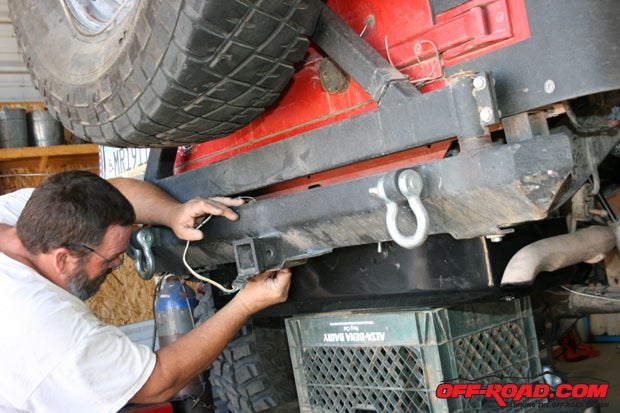 Use a floor jack to carefully raise the tank back into position. Reconnect the filler hose(s), all the fuel lines, and the electrical connections. Tighten all the mounting bolts.
