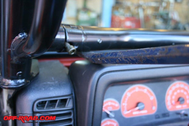 After securing the vertical support bars to the lower A-pillar, install the lower crossbar just above the dash, and reinstall the plastic side panels.