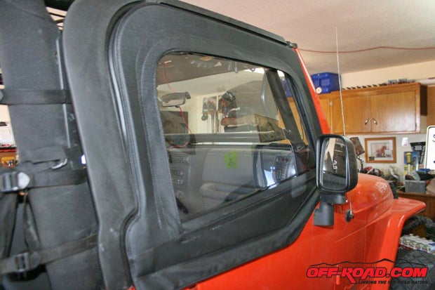 Align the posts in the half windows into matching holes in the half doorsin this case they are tube doors with skins painted to match the Jeep. Adjust the window frames to seal the upper opening.
