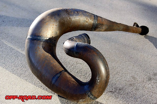 Curvy header pipes on 2-strokes looks great, they also serve as a velocity flow design to get rid of exhaust fast.