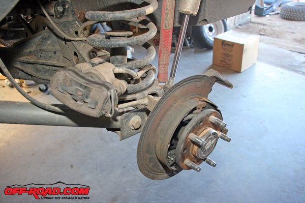 Since the Rubicons rear brakes use drum brakes for the parking brake system, it requires a backing plate. This one has suffered ten New Hampshire winters and thats why its so rusty.