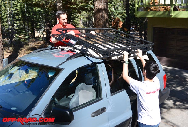 To keep from damaging the paint on our Grand Cherokee, we put a blanket down on the roof and had a helping hand to get the rack in place. The rack isnt exactly light but its also not super heavy so much as its awkward due to its size, so its a bit much for just one person to handle confidently.