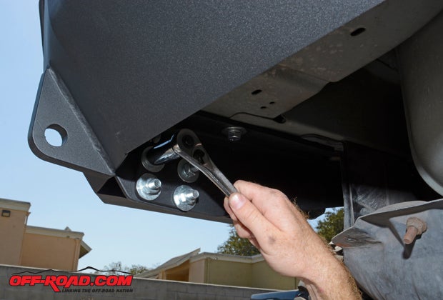 An extra set of hands will come in handy to set the bumper in place. Once in place, there are four bolts that secure the bumper to the frame mounts on each side. Install each bolt finger tight at first, slowly tightening each bolt while making sure the bumper is properly lined up. 