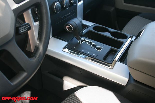 8.	Equipped with an electronic transfer case control, the Ram 1500s transmission shifter was mounted in the center console. While in drive, a tap on the handle to the left dropped the tranny a gear and a tap to the right shifted the tranny upward. The consoles upper compartment provides a good working surface