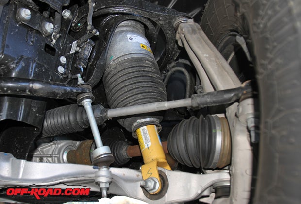 Some vehicles are fitted with adjustable suspension systems, such as this system found on the Ram 1500 Rebel. This four-corner system actually wraps around the shock and can be raised and lowered from inside the cabin with the push of a button.