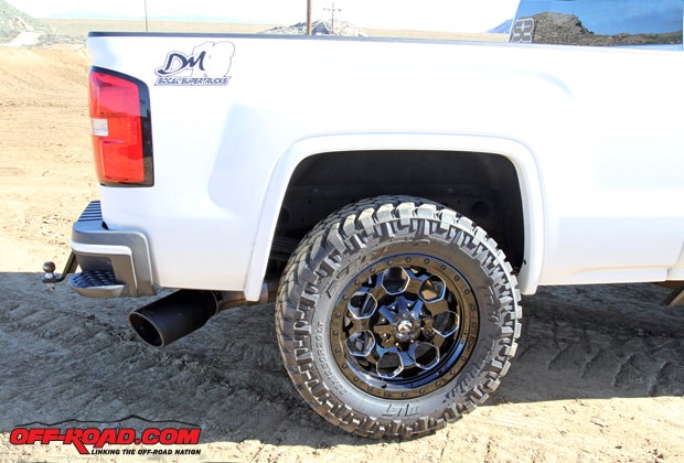 The Sierra features new Fuel Offroad 20 x 9 D563 Savage Wheels fitted with 35 x 12.50 Nitto Trail Grappler Tires. Out back, an aFe Mach Force XP DPF-back exhaust is equipped, with the beefy 6-inch black tip visible just under the bumper.
