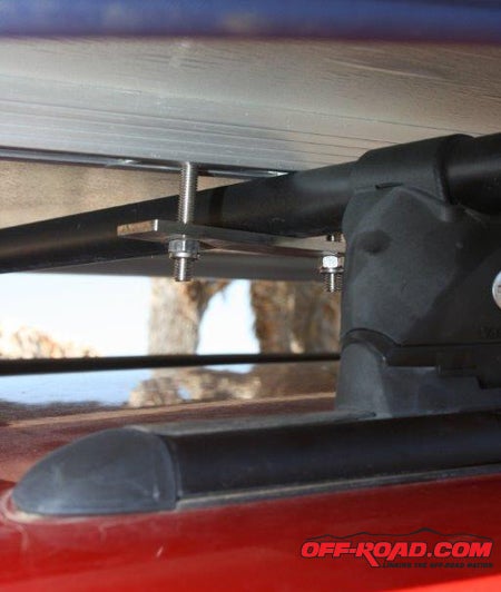 The CVT tent assembly attaches to the roof rack with four sliding and bolted clamps. The bolts slide in two full-width slotted tracks mounted to the floor of the tent.